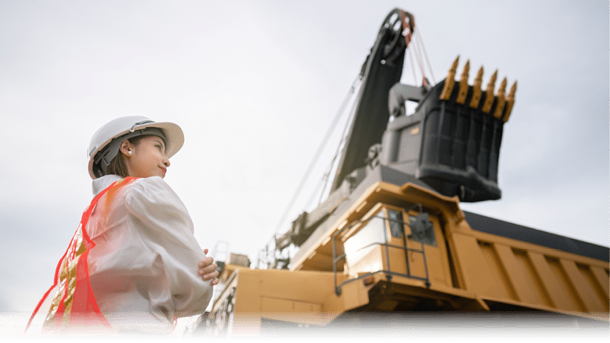 Worker in lignite or coal mining with the truck transporting coal.