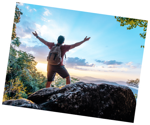 Rear view back of Young asian hiking man standing and rise-up hands with happy on peak of rocky mountain, copy space