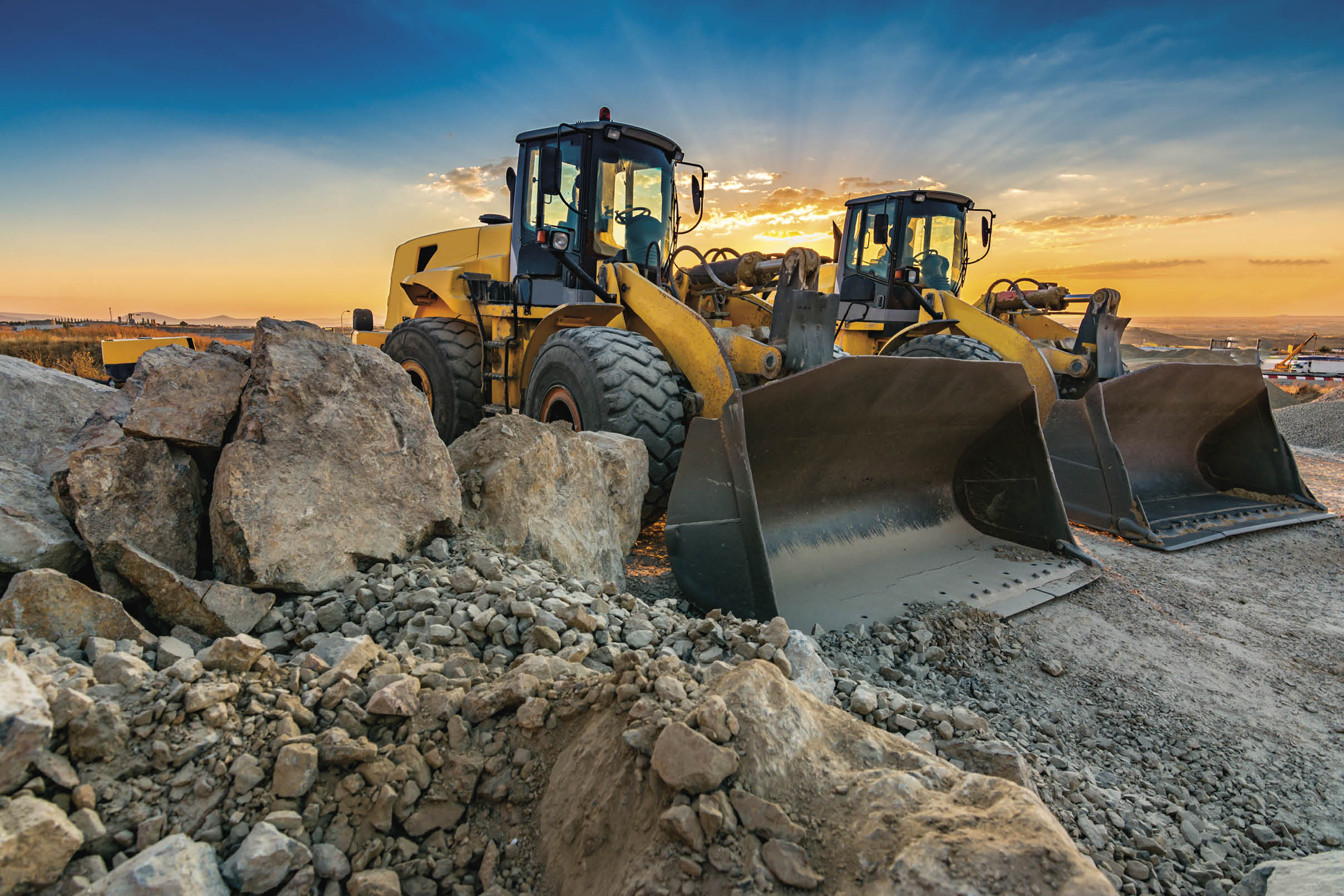 Two excavators removing stone in the construction works of a road